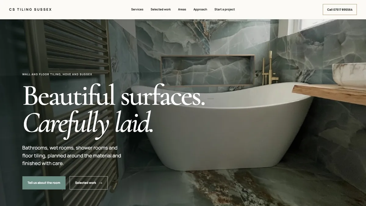 CS Tiling Sussex homepage with a freestanding bath against large-format marble-effect tiles and the headline Beautiful surfaces. Carefully laid.